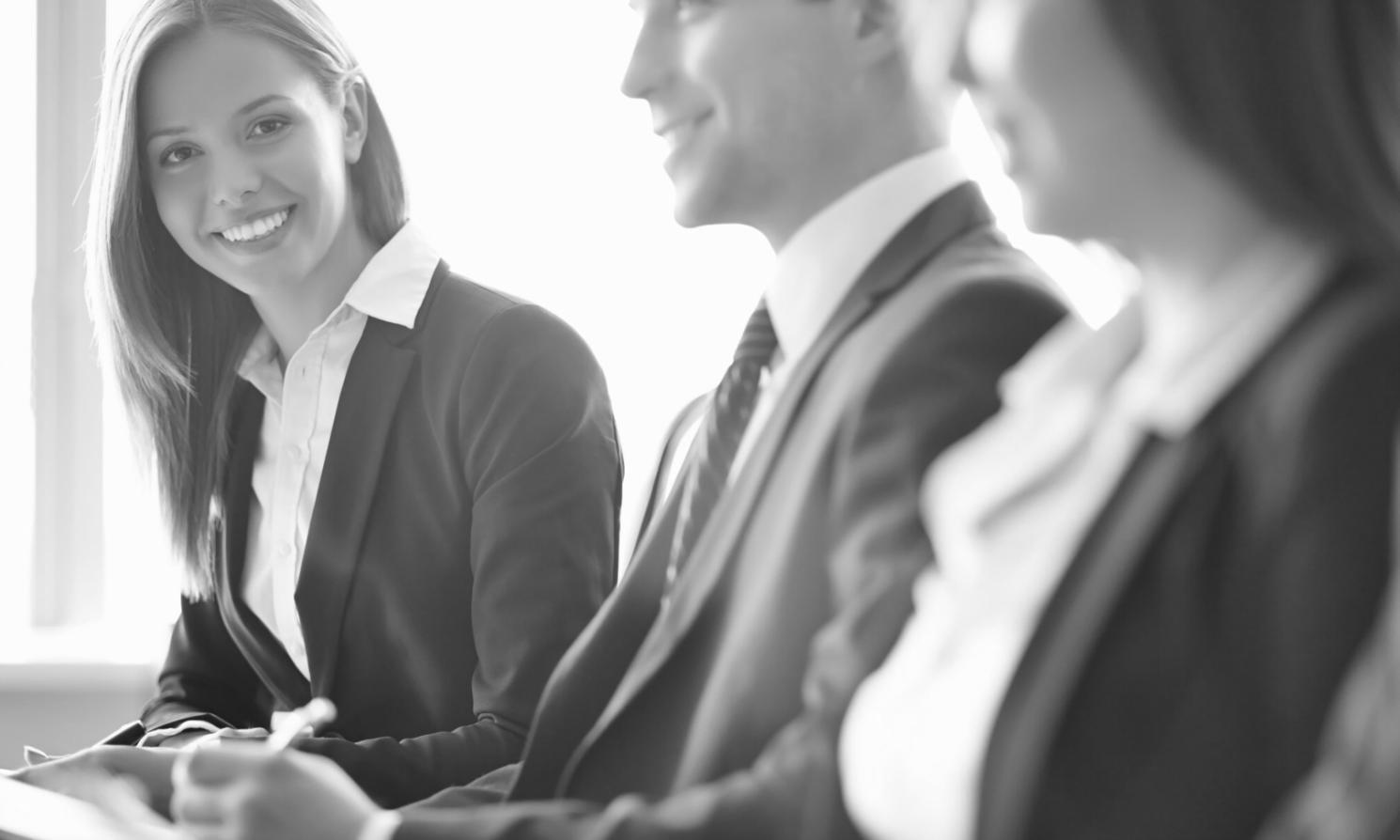 Personas revisando documentos financieros en una mesa de trabajo colaborativo